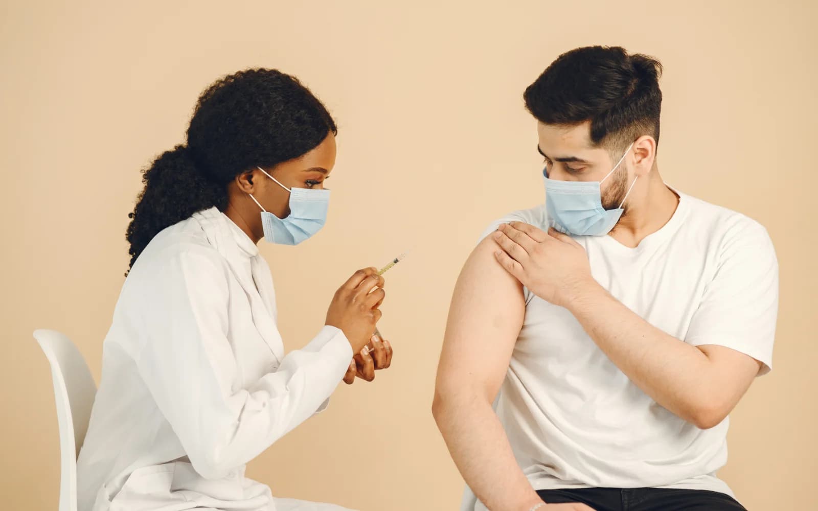 Profissional de saúde prepara a vacinação de um adulto